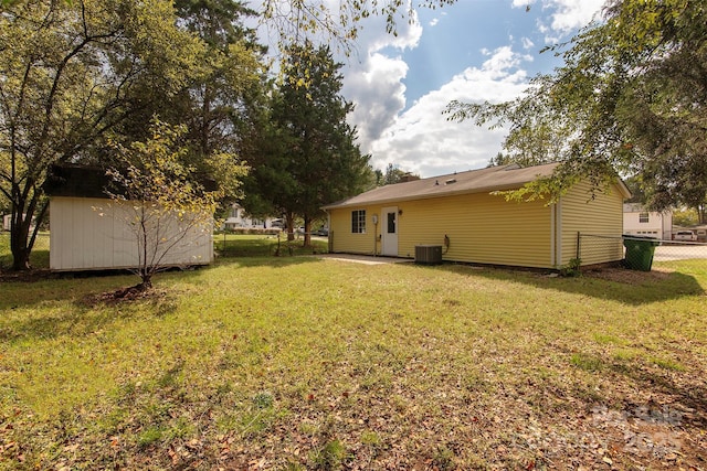 view of yard featuring a shed and central AC unit