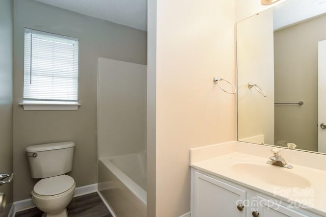 bathroom with hardwood / wood-style flooring, vanity, and toilet