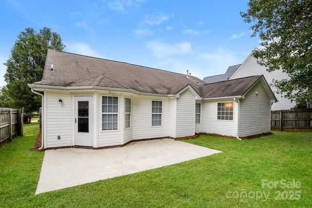 back of property with a lawn and a patio