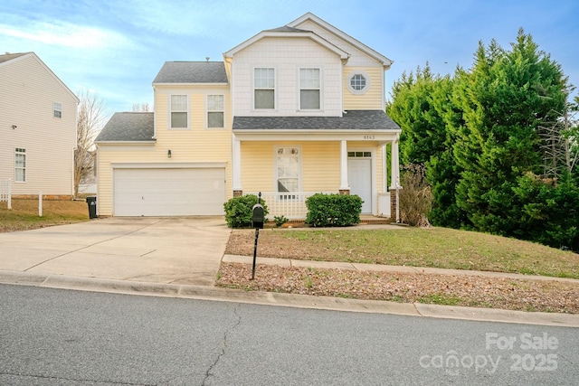 view of front property with a porch, a garage, and a front yard