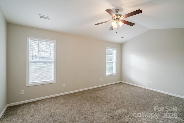 carpeted empty room featuring lofted ceiling and ceiling fan