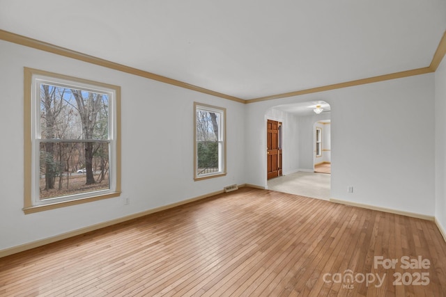 unfurnished room with crown molding and light wood-type flooring