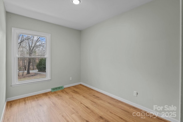 spare room featuring hardwood / wood-style floors