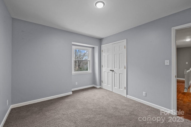 unfurnished bedroom with carpet flooring and a closet