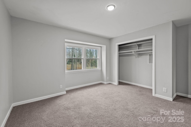 unfurnished bedroom with carpet flooring and a closet