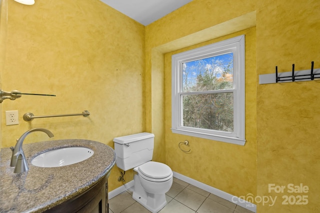 bathroom featuring vanity, tile patterned floors, and toilet