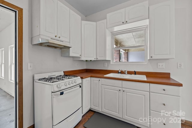 kitchen featuring white cabinetry, white range with gas cooktop, and sink