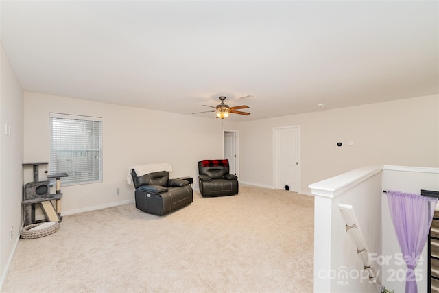 sitting room featuring ceiling fan and carpet