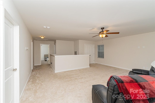 living room with ceiling fan and light carpet