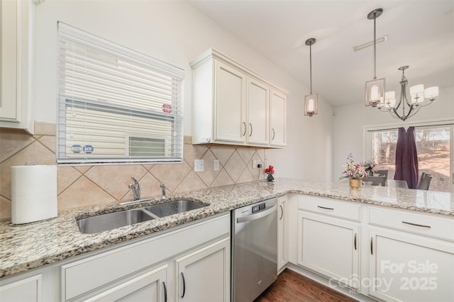 kitchen with a sink, light stone countertops, dishwasher, tasteful backsplash, and pendant lighting