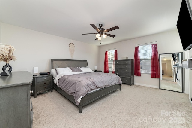 bedroom featuring baseboards, a ceiling fan, and light colored carpet