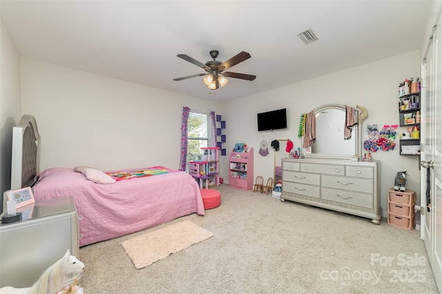 carpeted bedroom featuring visible vents and a ceiling fan