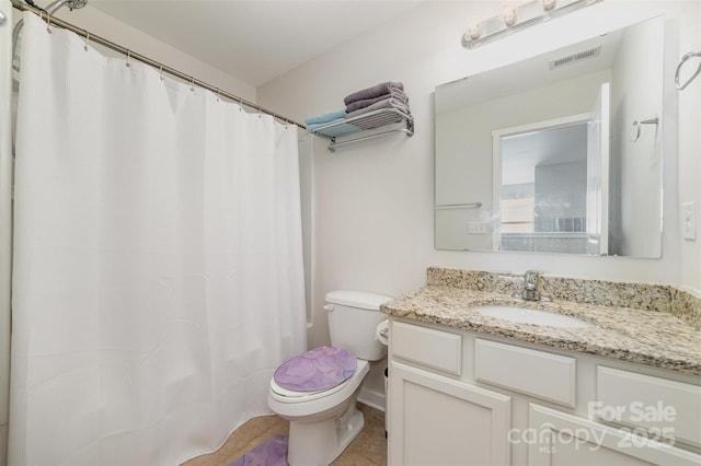 bathroom with tile patterned flooring, visible vents, vanity, and toilet