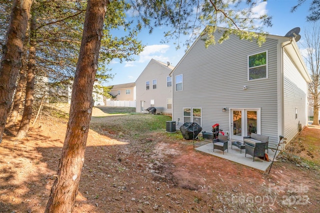 rear view of house featuring a patio area and central air condition unit