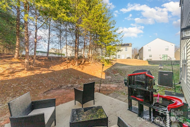 view of yard featuring an outdoor living space and central AC