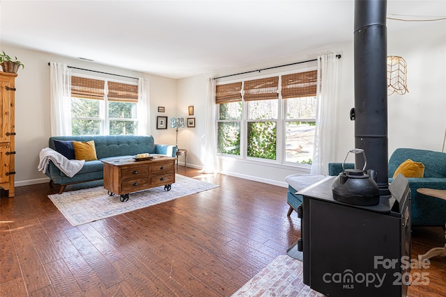 living room with dark hardwood / wood-style flooring and a wealth of natural light