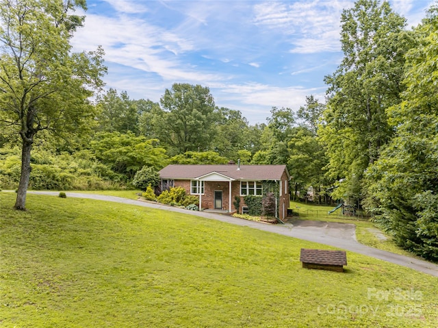 170 Hillcrest Dr, Columbus, NC 28722 - view of front of home featuring a front lawn, brick siding, and asphalt driveway