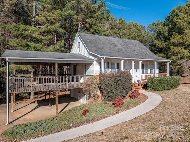 view of front of house with a carport and a porch