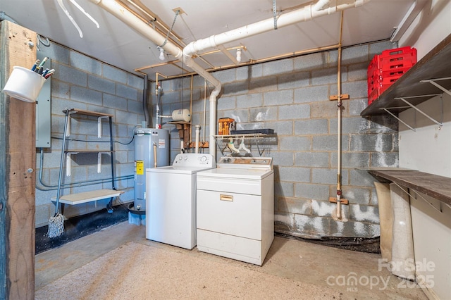 clothes washing area featuring washer and clothes dryer and water heater