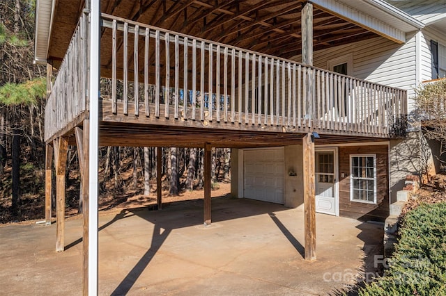 view of patio / terrace with a wooden deck and a garage