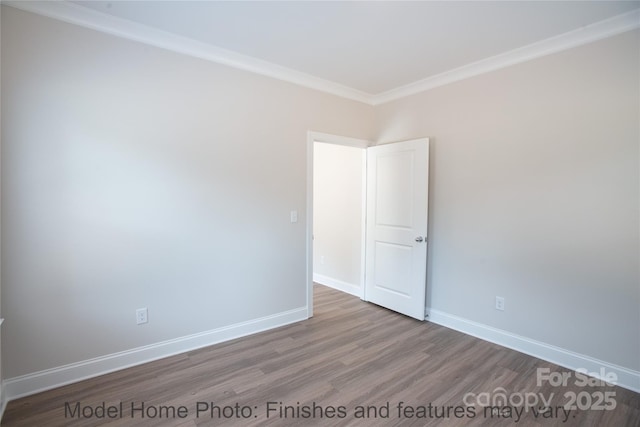 unfurnished room featuring hardwood / wood-style floors and crown molding