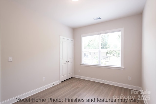 unfurnished room with light wood-type flooring