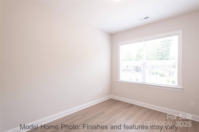 spare room with light wood-type flooring