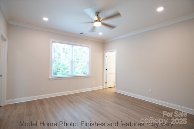 spare room with crown molding, ceiling fan, and light hardwood / wood-style flooring