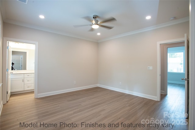 unfurnished room featuring crown molding, ceiling fan, and light wood-type flooring