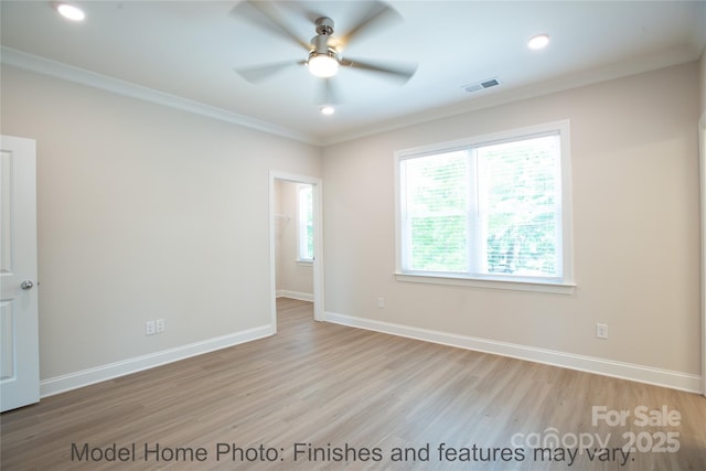 unfurnished room with light hardwood / wood-style flooring, ornamental molding, and ceiling fan