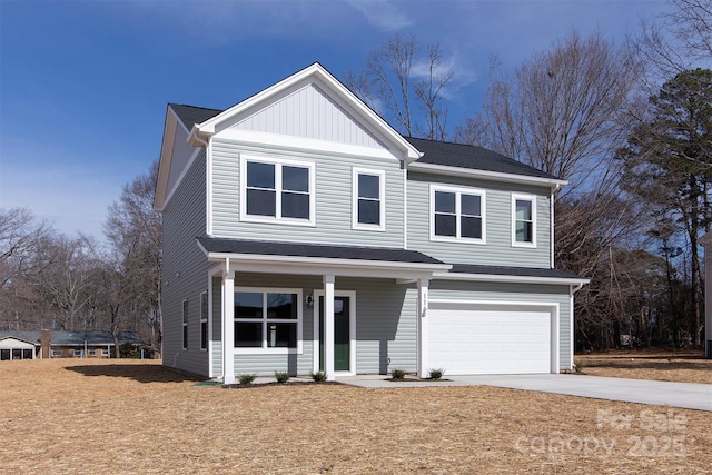 traditional-style house featuring a garage, concrete driveway, and board and batten siding