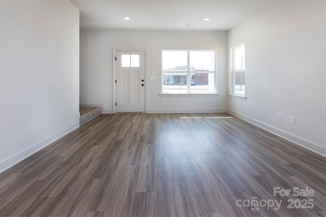 entryway with dark wood-style flooring and baseboards