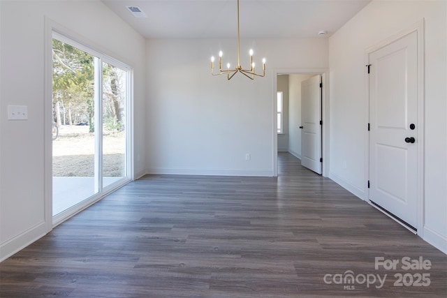 unfurnished dining area featuring visible vents, dark wood finished floors, a notable chandelier, and baseboards