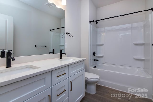 bathroom featuring  shower combination, double vanity, visible vents, and a sink