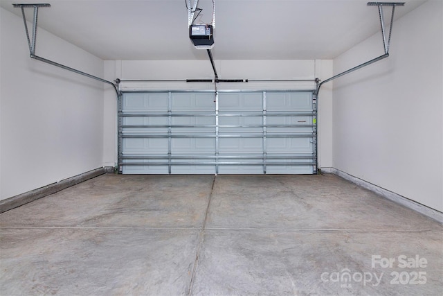 garage with baseboards and a garage door opener