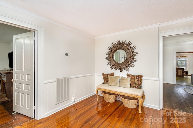 living area with crown molding and dark hardwood / wood-style floors