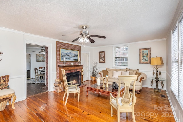 living room with wood-type flooring, a textured ceiling, and crown molding