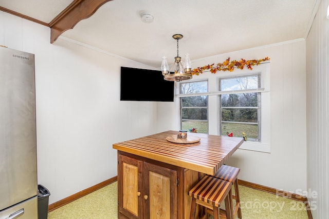 dining area featuring crown molding and a notable chandelier