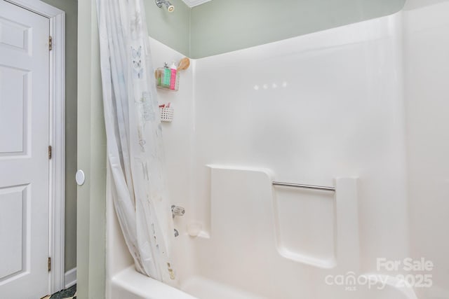 bathroom with shower / bathtub combination with curtain