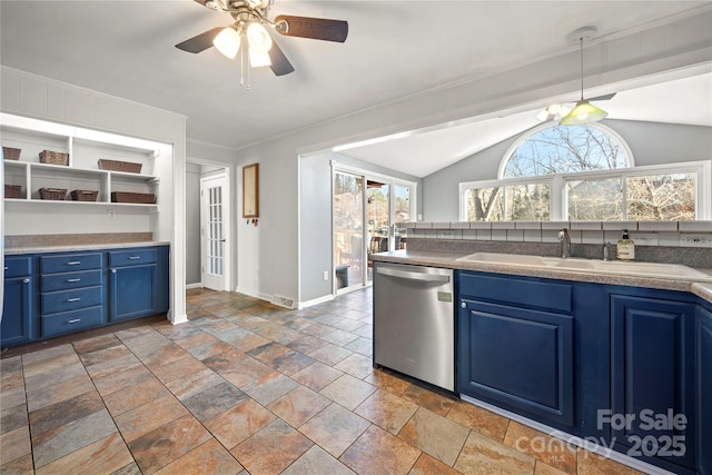 kitchen with blue cabinetry, sink, vaulted ceiling, hanging light fixtures, and dishwasher