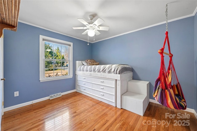 unfurnished bedroom with crown molding, light hardwood / wood-style floors, and ceiling fan