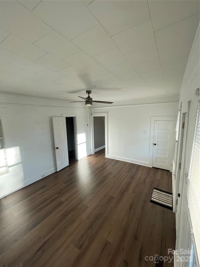 interior space with ceiling fan and dark hardwood / wood-style flooring