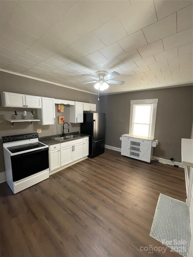 kitchen with white cabinets, sink, black refrigerator, and electric range