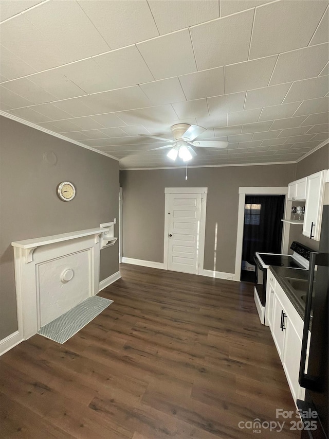 interior space with crown molding, ceiling fan, white cabinetry, electric range oven, and dark hardwood / wood-style floors