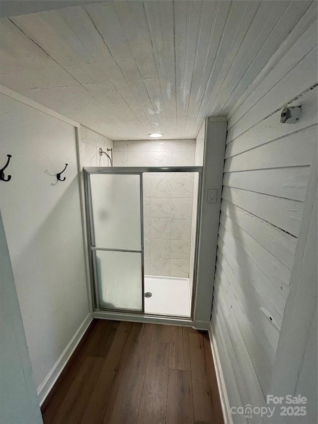 bathroom featuring hardwood / wood-style flooring and wooden ceiling