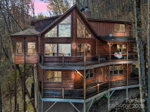 back house at dusk with a balcony