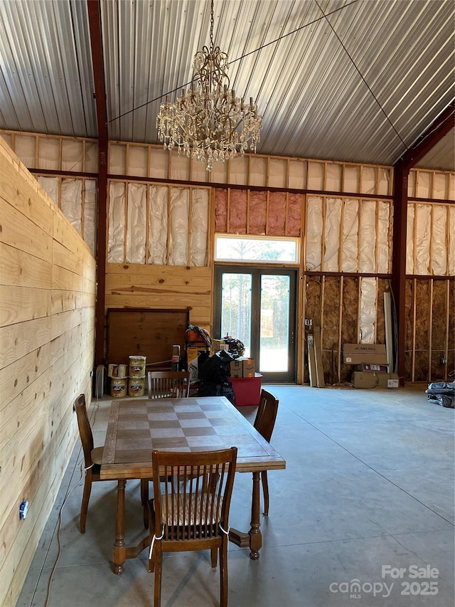 dining room with an inviting chandelier and concrete flooring