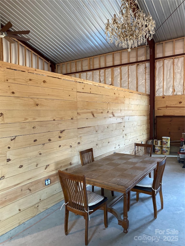 unfurnished dining area featuring a notable chandelier and concrete floors