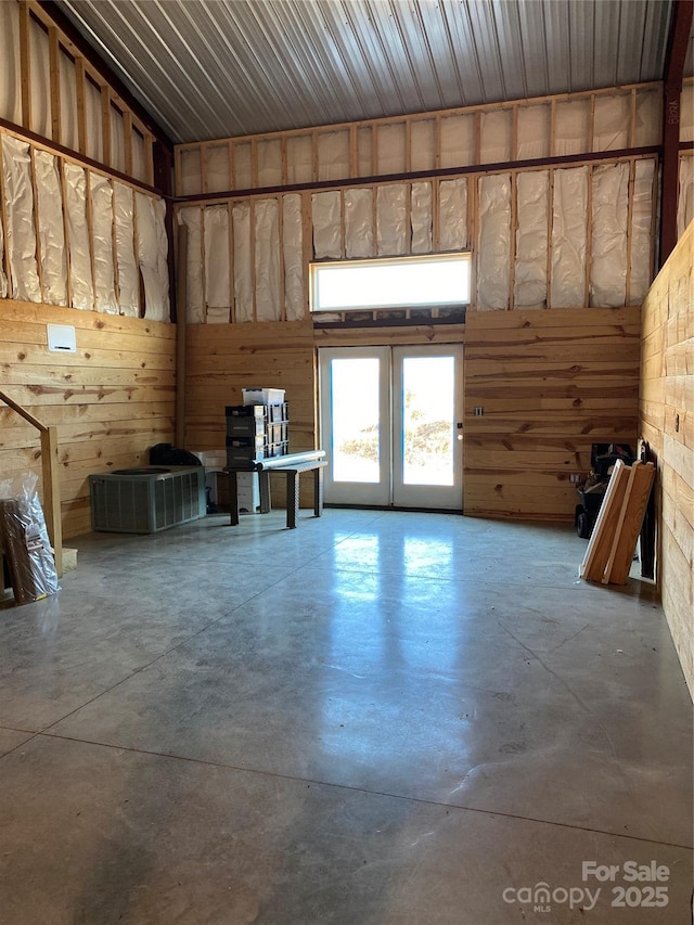 interior space with concrete flooring and french doors