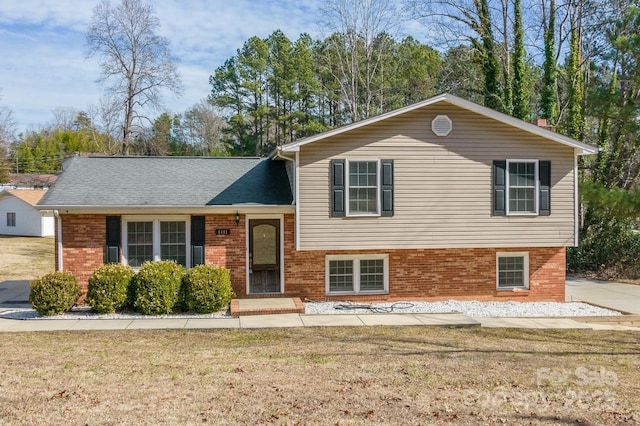 split level home with a front lawn